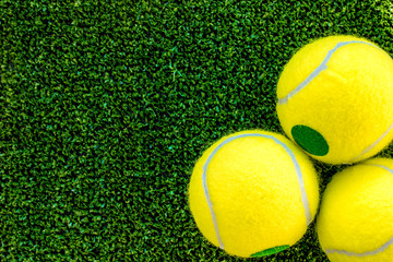 Wall Mural - tennis ball on green background top view mock up