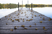 Wooden Pier Over Calm Lake During Autumn