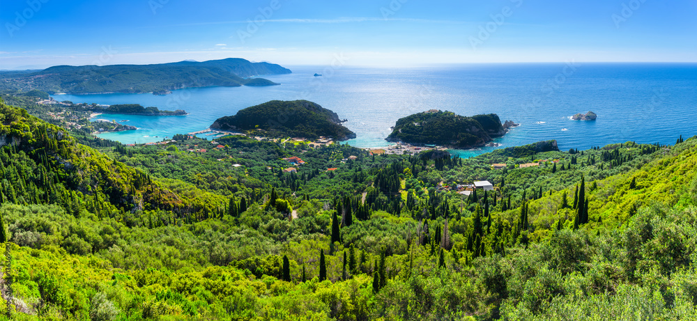 Beautiful summer panoramic seascape. View of the coastline into the sea bays with crystal clear azure water. In the backlight sunbeam light. Paleokastrica. Corfu. Ionian archipelago. Greece. - obrazy, fototapety, plakaty 