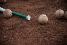 Baseball Bat And Balls On Floor