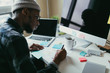 © ZeroThree - African american man writing some notes