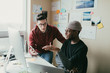 © ZeroThree - Two men working togehter in a small home office.