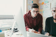 © ZeroThree - Two men working togehter in a small home office.
