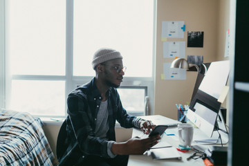 Wall Mural - African american man working in his bedroom office