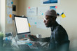 © ZeroThree - African American Man Working At His Desk