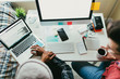 © ZeroThree - Overhead view of friends working on a coding project