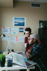 Two People Collaborating Around A Computer