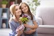 © Africa Studio - Beautiful young woman with present and bouquet of flowers from her daughter. Mother's day concept
