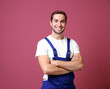 © Africa Studio - Handsome young worker on color background
