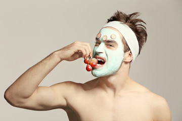 Canvas Print - Man with cosmetic mask on face, gray background