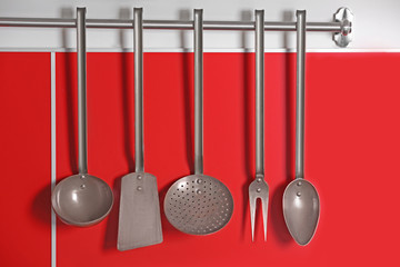 Canvas Print - Set of metal kitchen utensils hanging on wall