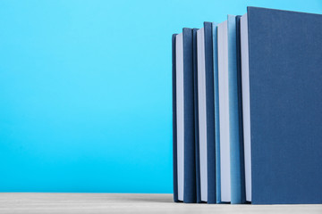 Poster - Books on wooden table and blue background