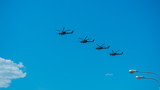 Fototapeta Na sufit - Four combat helicopters flying over the city