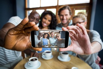 Group of friends taking a selfie from mobile phone