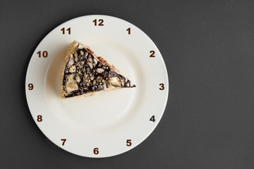 Napoleon layered cake on plate with clock face. Top view.