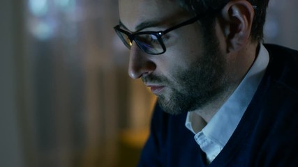 Aufkleber - Close-up of a Man at Home Working on a Computer. He Wears Glasses, Screen Reflects in Them. Shot on RED EPIC-W 8K Helium Cinema Camera.