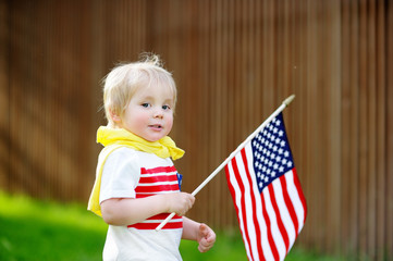 Wall Mural - Cute toddler boy holding american flag