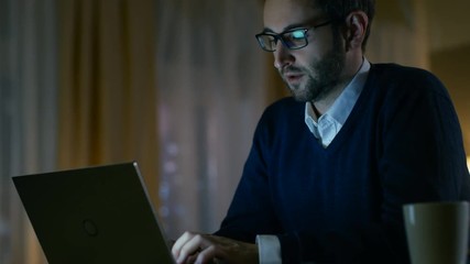 Aufkleber -  Middle Aged Man at Home Puts on His Glasses and Starts Working on a Laptop. In the Background His Stylish Flat in Yellow Tones. Shot on RED EPIC-W 8K Helium Cinema Camera.