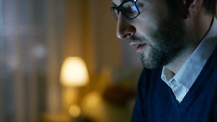 Aufkleber - Close-up of a Middle Aged Man Working on a Laptop. He's at Home Alone. Computer's Screen Reflects in His Glasses. Shot on RED EPIC-W 8K Helium Cinema Camera.