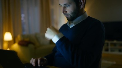 Aufkleber - Close-up of a Respectable Middle Aged Man Working on a Laptop. He's at Home Alone. In the Background His Flat Looks Stylish and Has Skyscrapers View.  Shot on RED EPIC-W 8K Helium Cinema Camera.