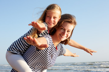 Happy family resting at beach in summer