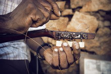 Cropped Image Of Man Fixing Strings On Guitar