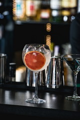 refreshing ruby red coctail with grape fruit isolated on a bar b