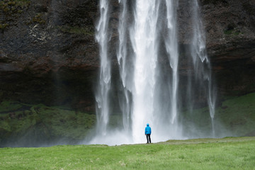 Wall Mural - Tourist near a Seljalandsfoss waterfall in Iceland