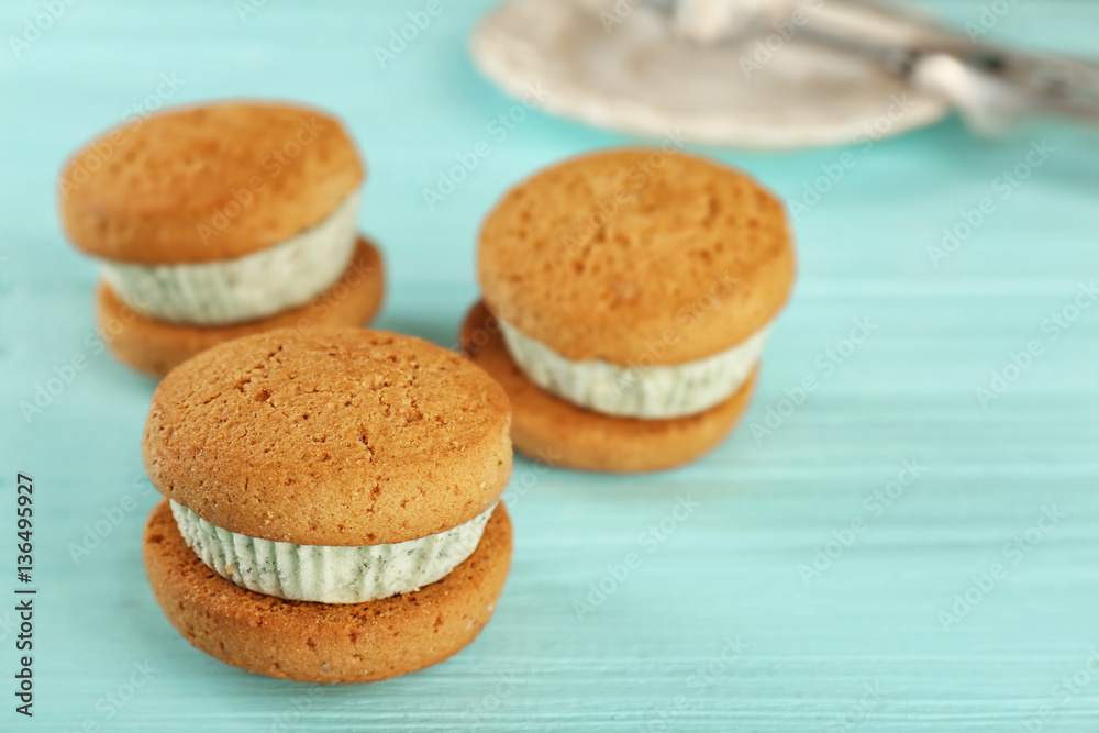 Ice cream cookie sandwiches with fresh mint on blue wooden background