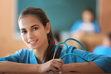 Canvas Print - Young female student at lecture indoors