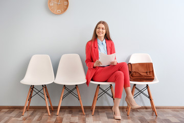 Young woman waiting for interview indoors