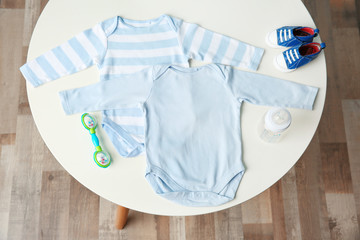 Wall Mural - Set of baby clothes on light table