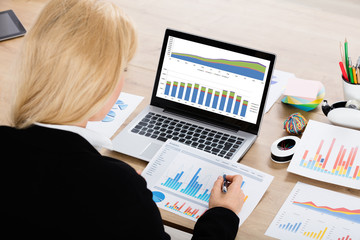 Poster - Businesswoman Analyzing Financial Graphs