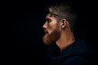 © USM Photography - Close-up image of serious brutal bearded man on dark background