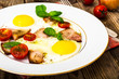 © ArtCookStudio - Fried eggs with bacon and vegetables on a white plate