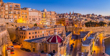 Valletta, Malta - The Traditional Houses And Walls Of Valletta, The Capital City Of Malta On An Early Summer Morning Before Sunrise With Clear Blue Sky