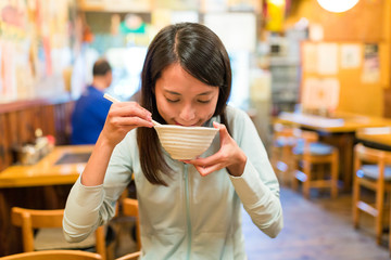 Poster - Woman eating soup in japanese restaurant