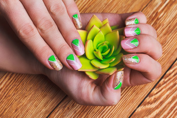 Wall Mural - Nail art with bright gold, pink and green chevron pattern