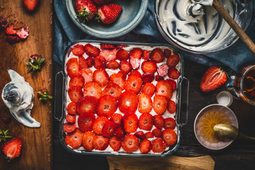 Wall Mural - Strawberries cake, cooking preparation with ingredients and kitchen tools, top view