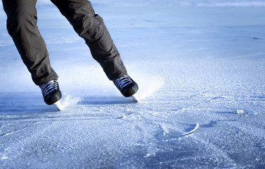 Wall Mural - The guy rides on skates on ice in the winter.