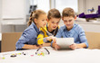 © Syda Productions - kids with tablet pc programming at robotics school