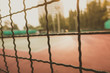 Golden hour Defocused and blurred image for background of tennis and basketball court behind grille and blur creamy sunflare