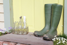 Green Wellington Boots Sitting On Doorstep