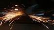 © branex - Worker grinding a metal construction with grinding wheel, lots of sparks in factory