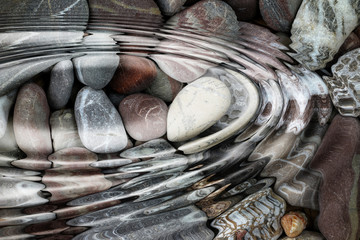 Water ripples over the stone pebbles