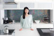 © taka - portrait of attractive asian woman in the kitchen
