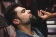 © Wavebreak Media - Man getting his beard trimmed with scissor