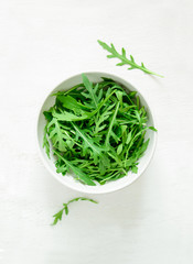 Wall Mural - Arugula leaves in a white bowl