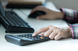 © PPstock - Woman's hands using calculator on table