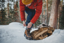 Traveller Hiking Young Man Man Tying Shoe On Winter Forest